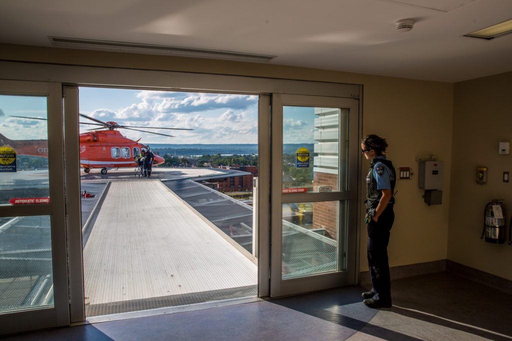 Security guard waits for paramedics to remove patient from the air ambulance