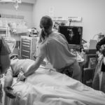A resident uses FAST (focused assessment with sonography in trauma) on the patient's abdomen to examine for possible injuries.