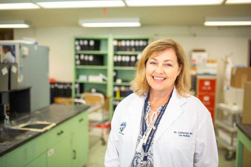 A portrait of Dr. Catherine Ross standing in a laboratory setting