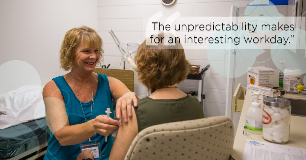 Employee health nurse provides a flu vaccine to an employee in a clinical office