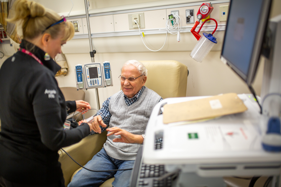 A nurse checks a patient's blood pressure