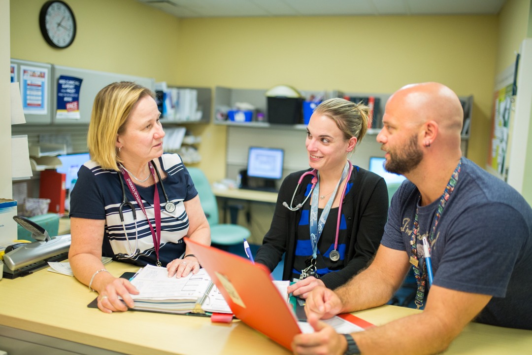 Three members of the pediatric oncology unit discuss protocol