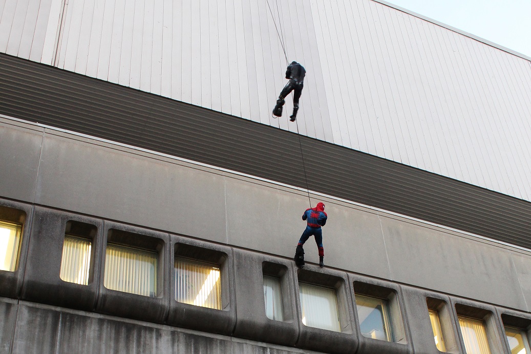 Spider-Man and Black Panther rappelling down the exterior of McMaster Children’s Hospital.
