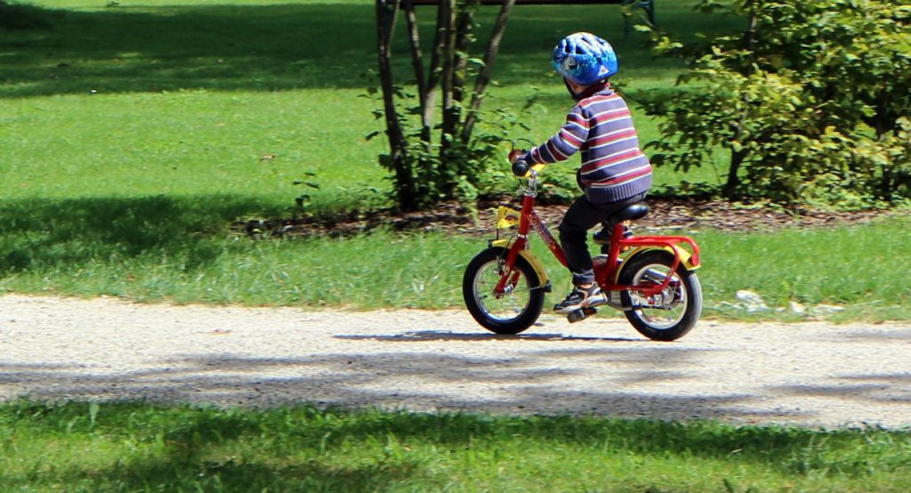 child riding bike with helmet