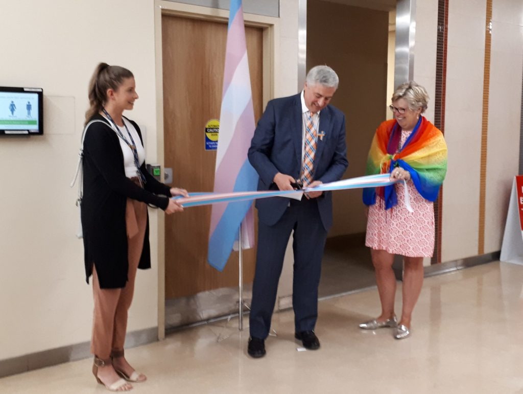 HHS President and CEO, Rob MacIsaac, cuts a ribbon on the new all gender washroom at McMaster University Medical Centre