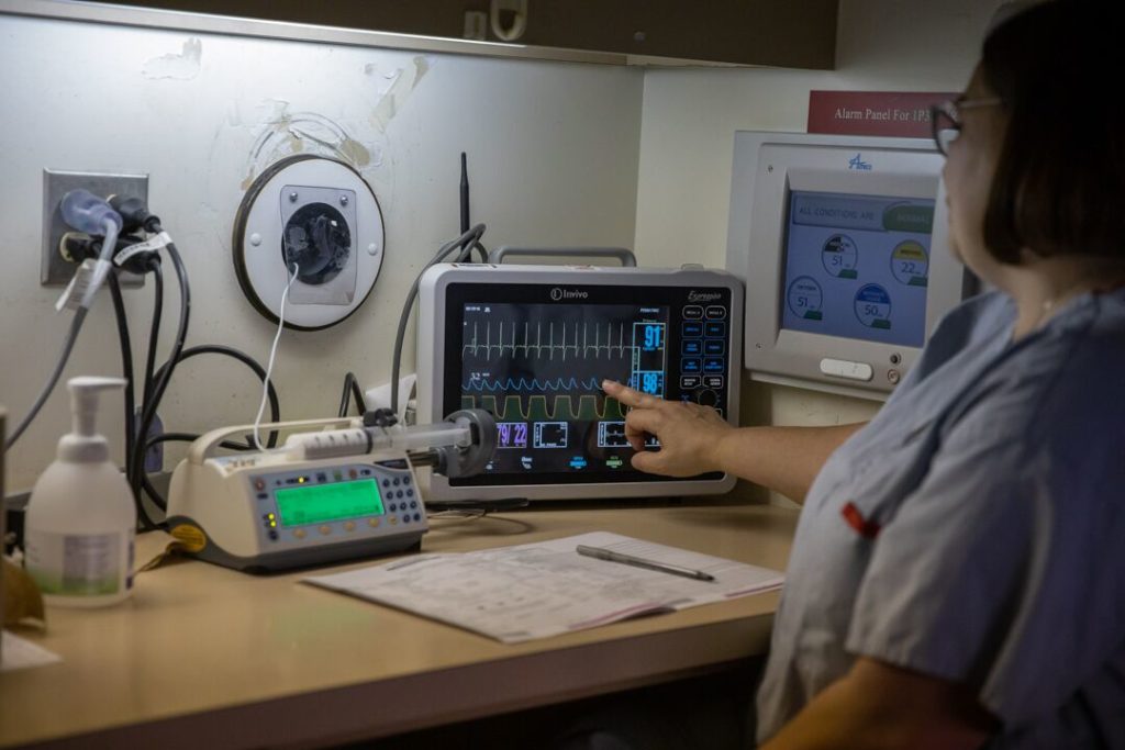 Dr. Bruce sits in room that overlooks the MRI scanner and tracks Sophie’s vital signs using a remote monitor. The medication used to keep Sophie asleep is fed through a long tube that connects to Dr. Bruce’s equipment through a porthole in the wall.