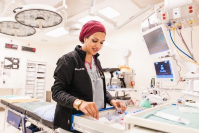 A pediatric anesthesiologist prepares in the operating room.