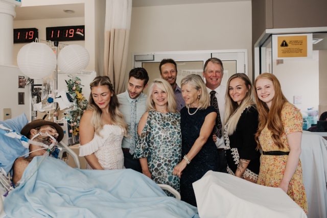 A family gathers around their husband and father's bedside for a wedding ceremony.