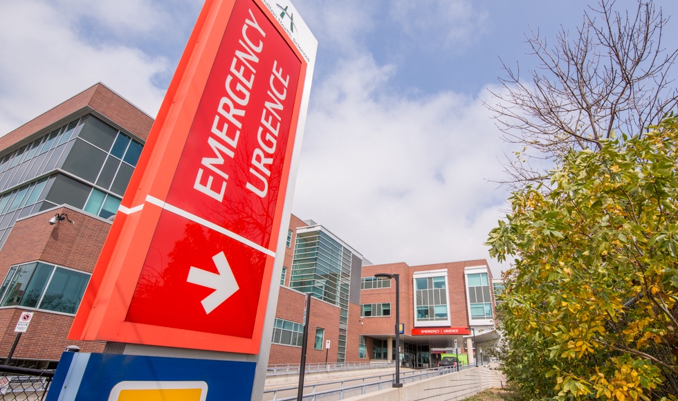 A outdoor sign pillar directing to the emergency department at Juravinski Hospital