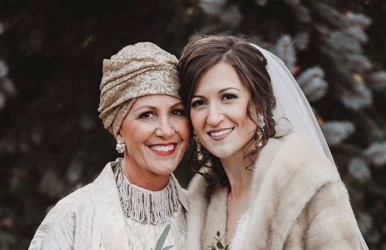 Tracey (left) smiles for a photo with her daughter (right) on her wedding day.