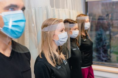 The ultrasound team models the extended face shield.