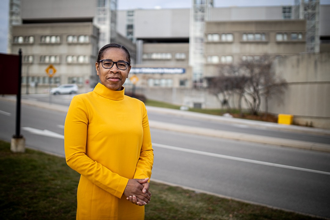 Leona Stewart standing in front of an HHS hospital site