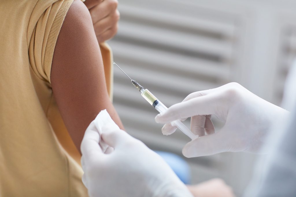 Stock photo close up of a doctor vaccinating a patient