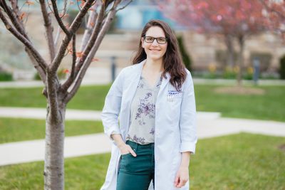 Doctor Celina Lin, long brown hair, glasses, wearing white lab coat