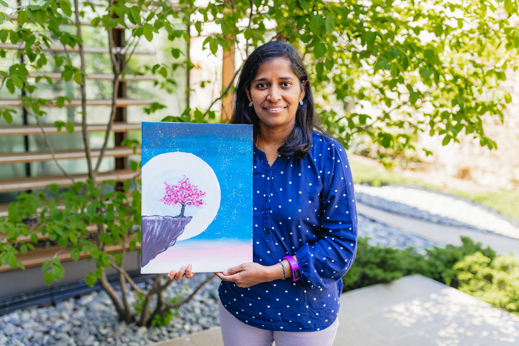 Suganya Vadivelu holding up a drawing she made during the art classes provided by Dundas Valley School of Art