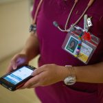 nurse holding a smart phone