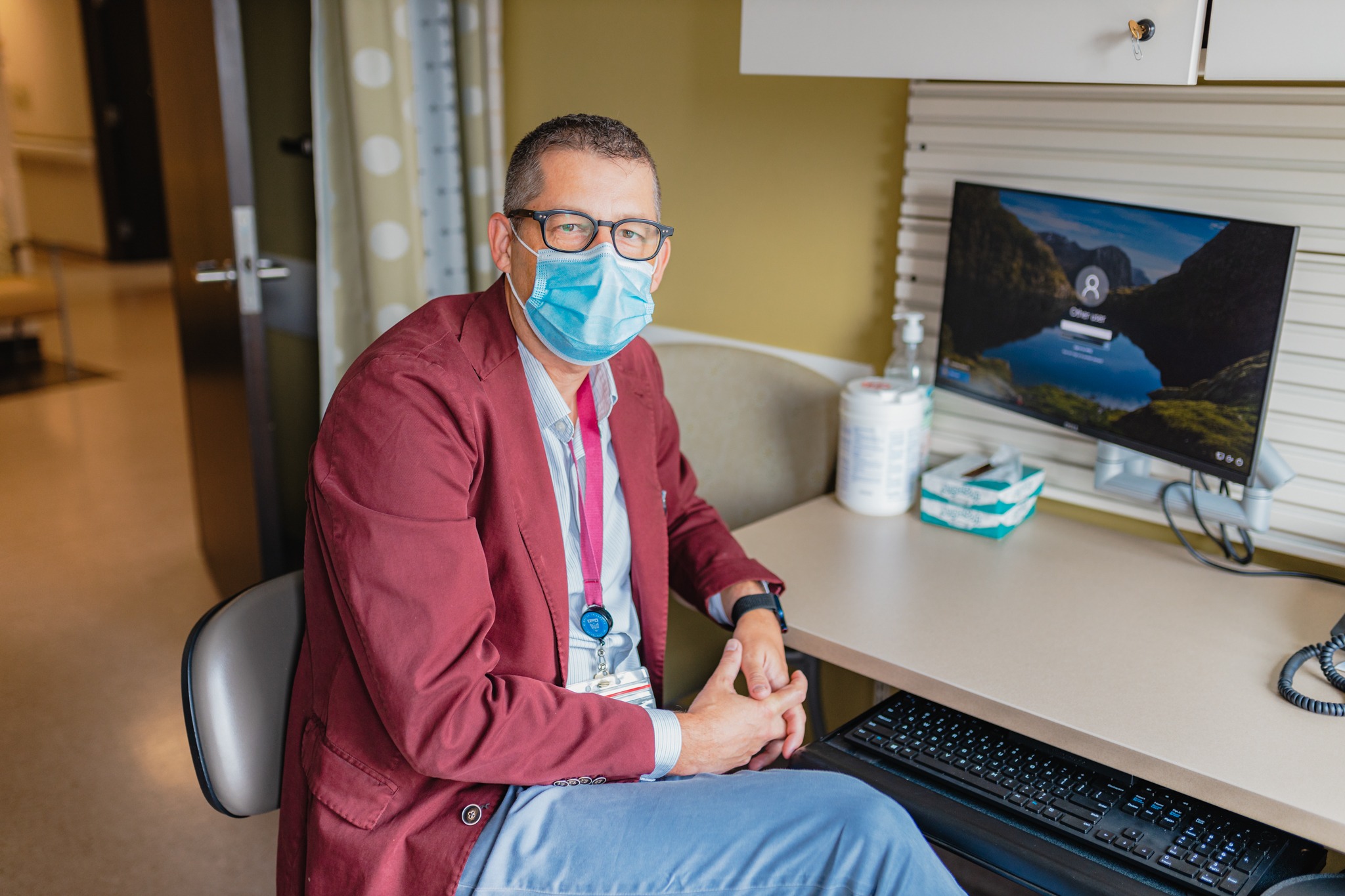 Dr. Cyr at his desk where he has virtual appointments with his patients