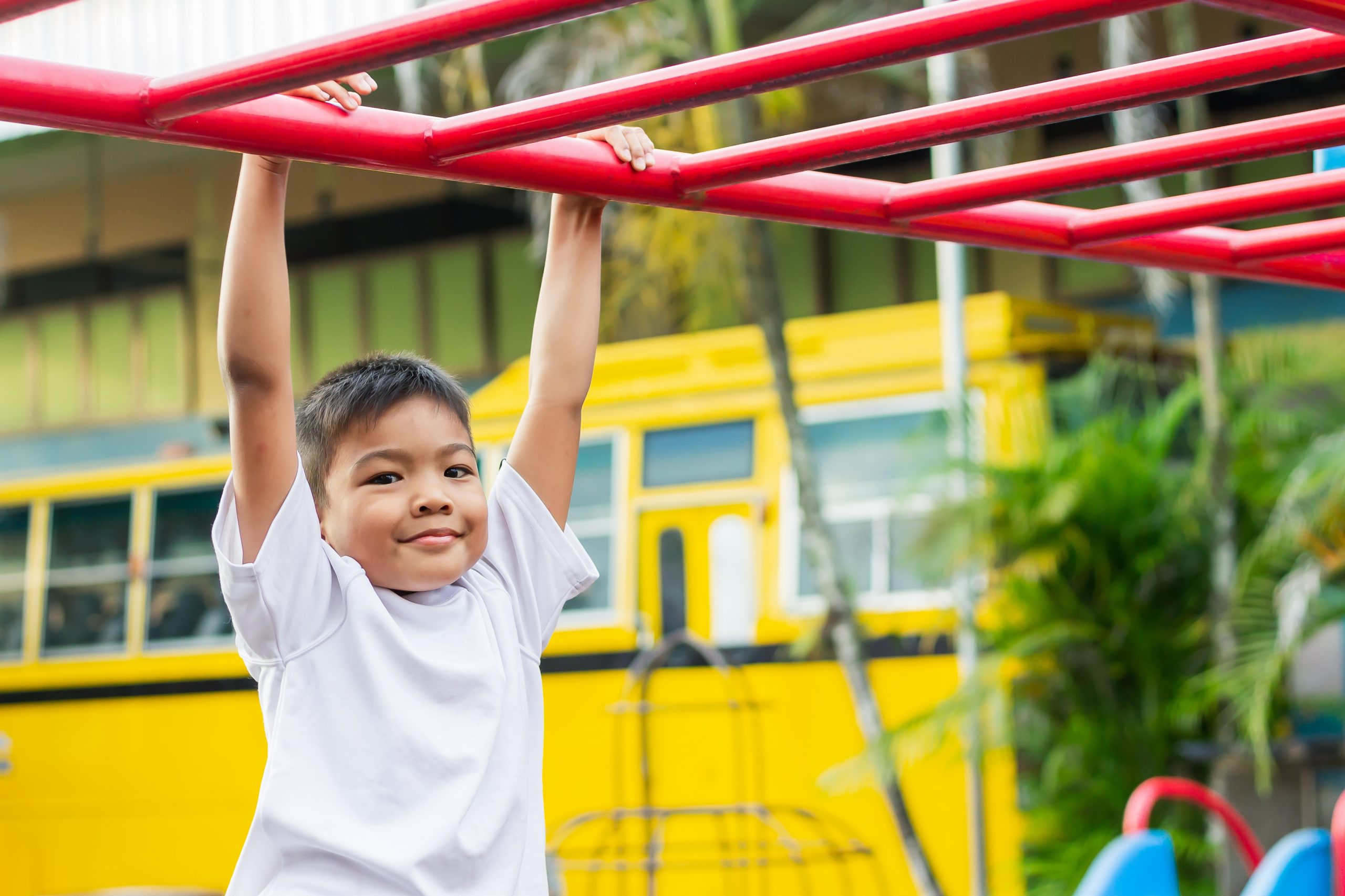 Child playing on monkey bars at a park