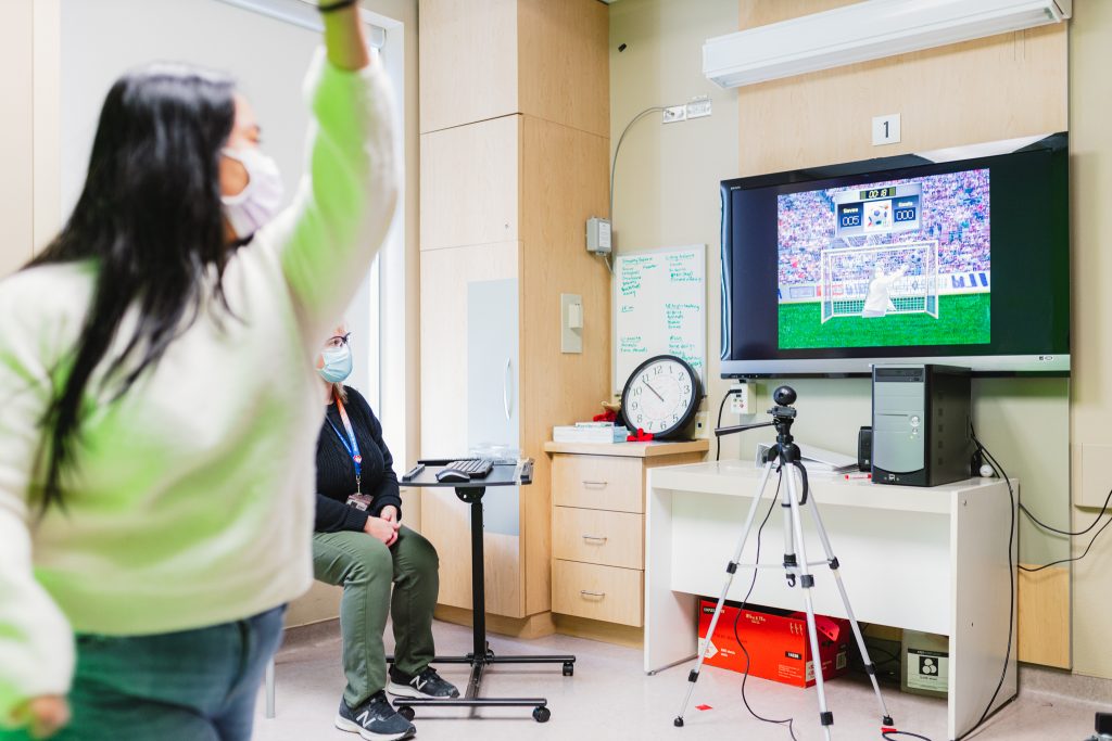 Rehab patient Lyndyl Smith demonstrates virtual reality soccer