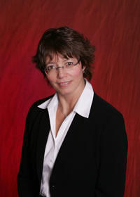Head and shoulders photo of Dawn Sidenberg, wearing a black blazer and white shirt