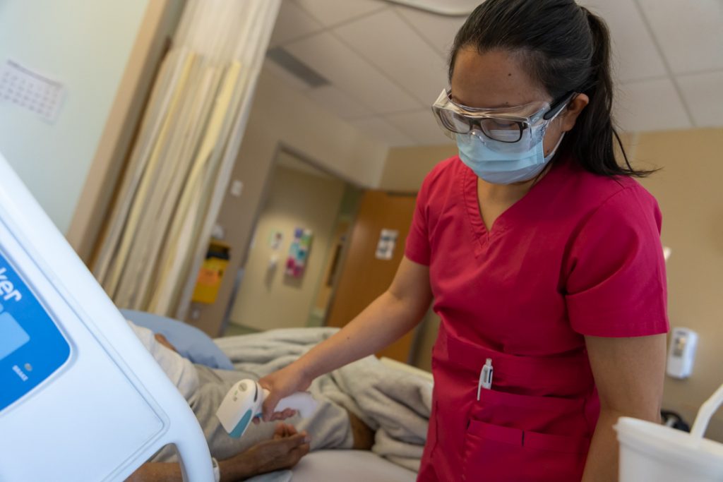 A nurse scans a patient's armband