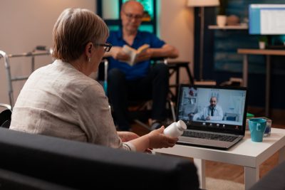 Woman doing a virtual appointment with her doctor from her home on a laptop