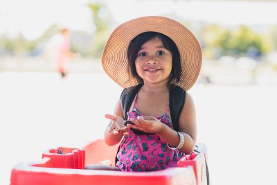 A preschool child in a straw hat, smiling