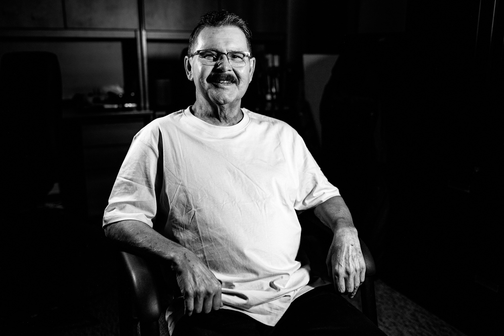 Black and white portrait of patient Danny Prosic, seated