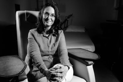Black and white portrait of Dr. Meghan Davis, seated
