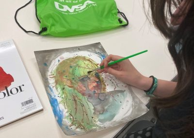 An unidentified teen works on a watercolor painting