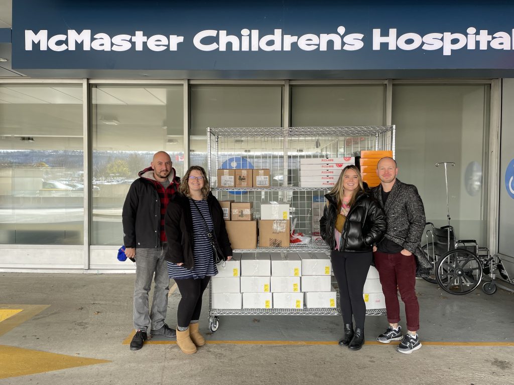 Family standing outside of the hospital with donations.