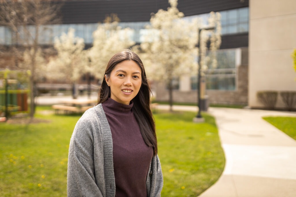 Clinical extern coordinator Christine Hui stands outdoors, smiling