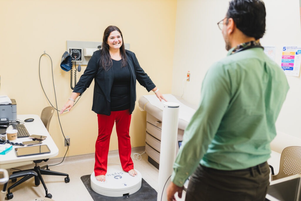 Dr. Pinto-Sanchez in the Celiac Disease Clinic standing on platform with a 3D scanning device in front of her.