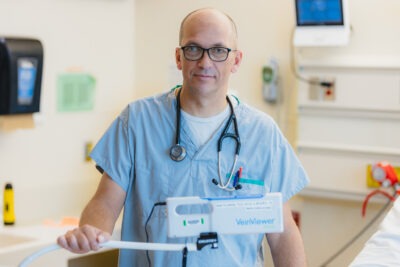 Photo of registered nurse Matt Scaum, holding the Vein Viewer Flex.