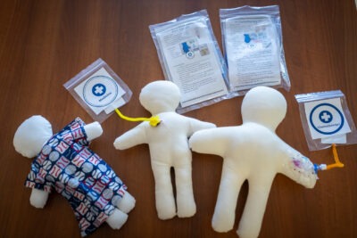 Medical dolls are used to show a PICC line and chemotherapy treatment 