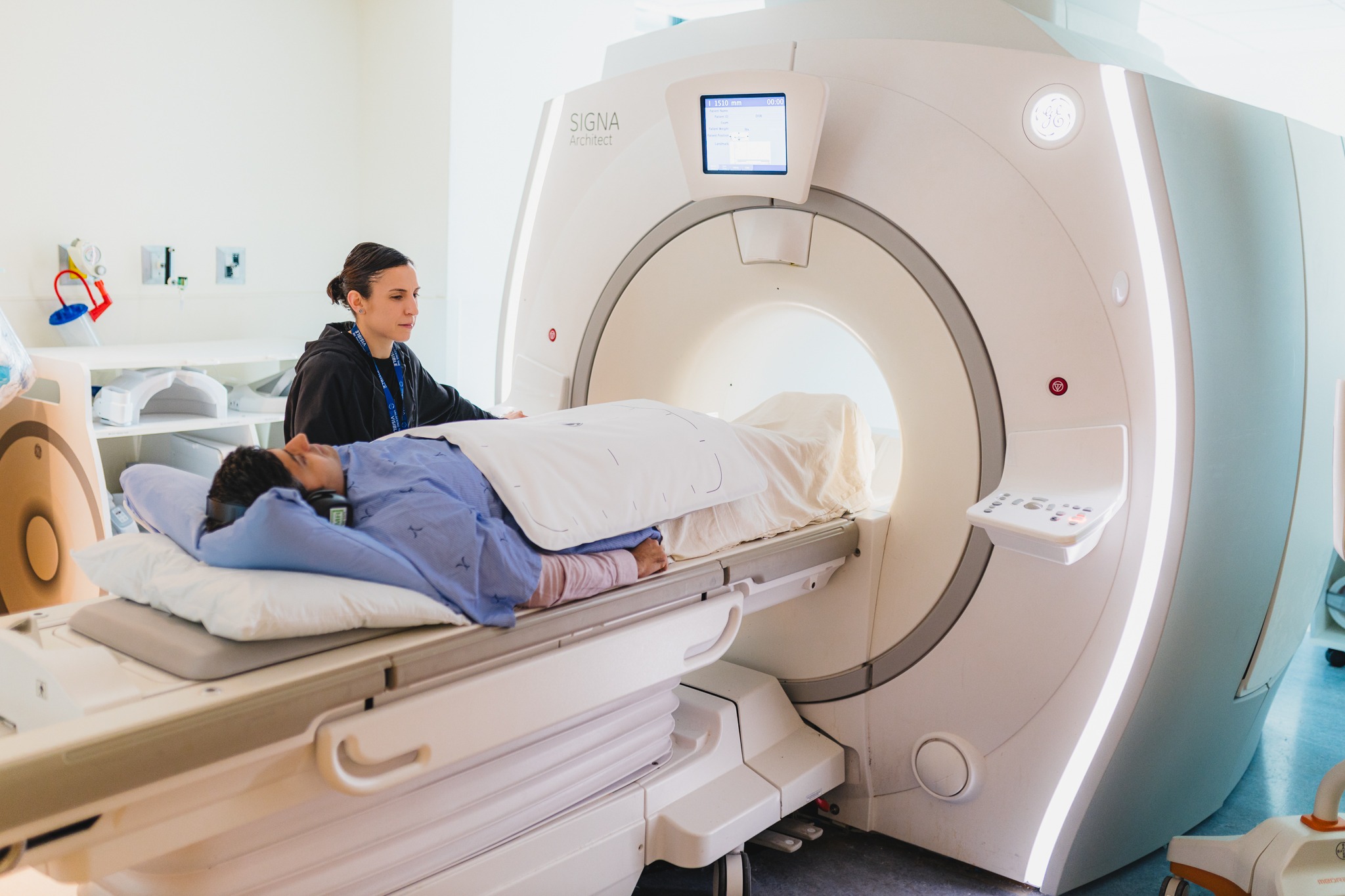 Senior MRI technologist Liz Teixeira and radiologist Dr. Ameya Madhav Kulkarni (who plays the patient in this photo) illustrate an MRI-ultrasound fusion biopsy procedure now available at Juravinski Hospital and Cancer Centre.