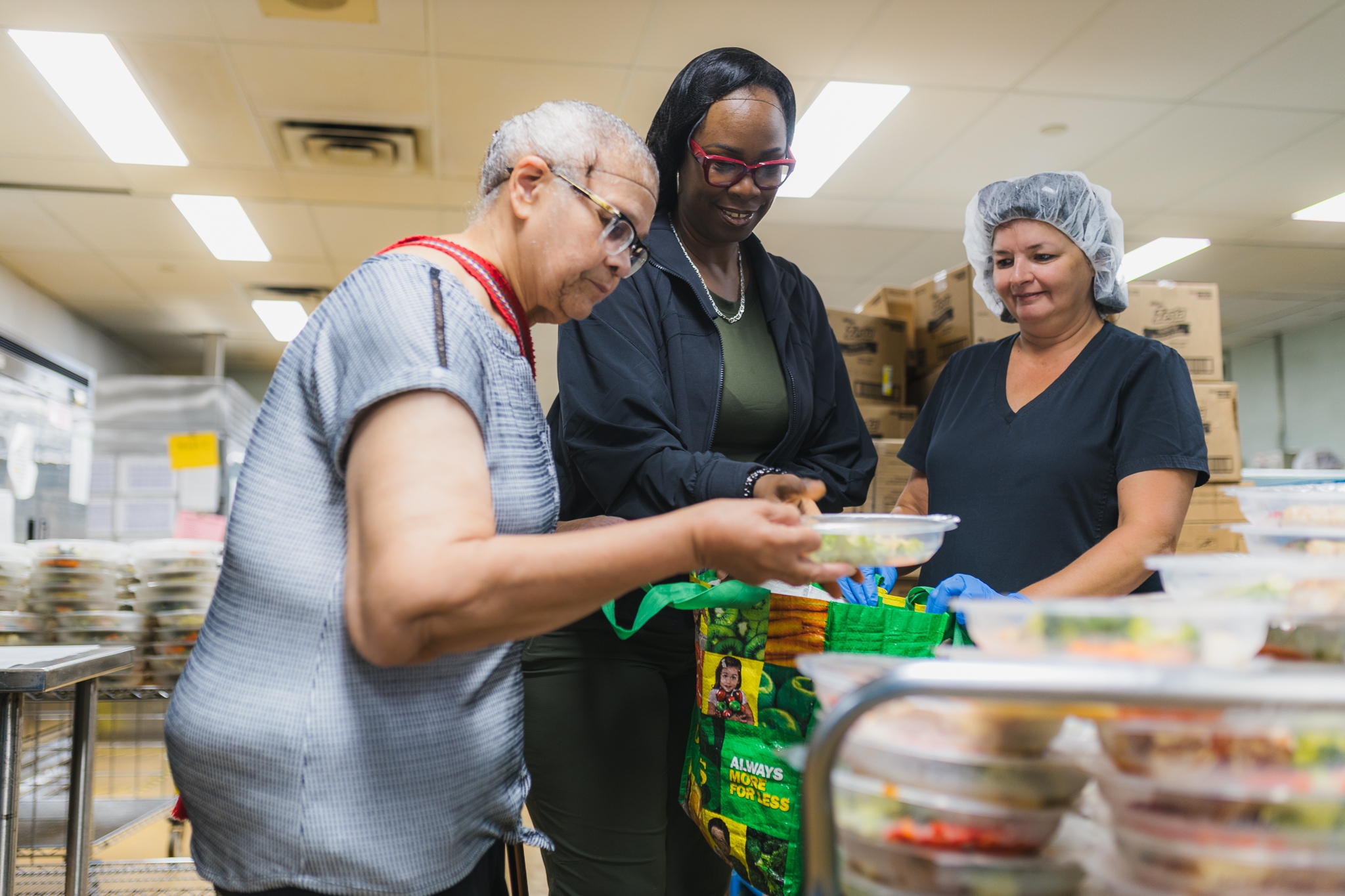 Donating surplus, never-served hospital food nearing its best-before dates to local charities is part of an HHS strategy to cut greenhouse gas emissions by reducing food waste. Aileen Duncan (left) and Michelle Dunbar (centre) from Stewart Memorial Church pick up surplus hospital dinners at our Hamilton General Hospital with help from Lillian Potter (right), a receiver with nutrition services. The church, in Hamilton's north end, distributes dinners to help combat food insecurity.