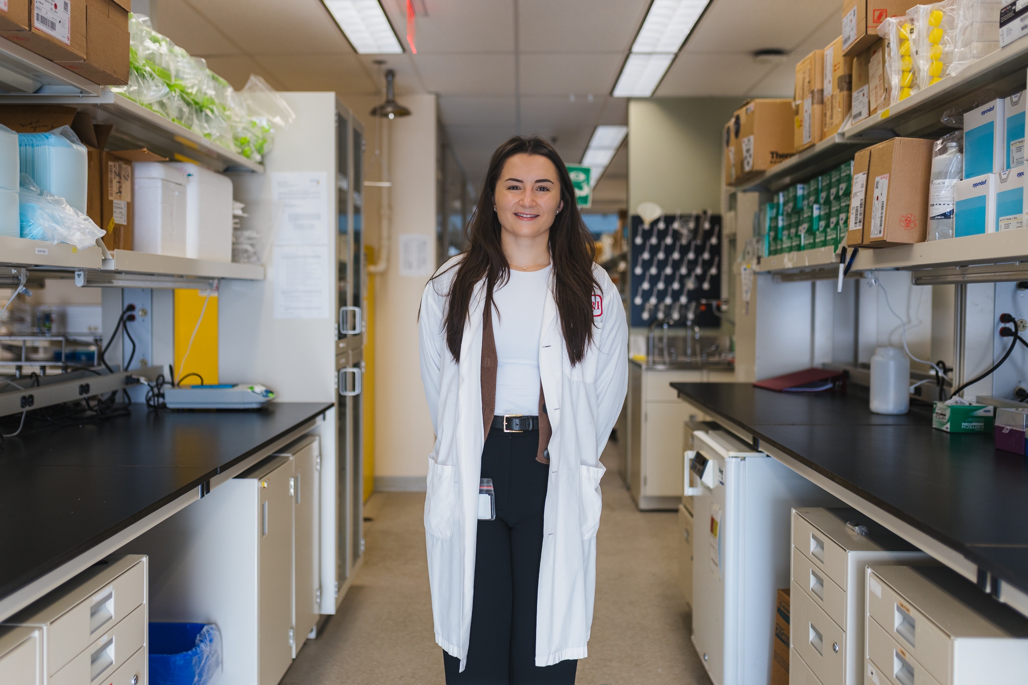Diana Tedesco stands in a lab area of the HHS Centre for Burn Research, wearing a white lab coat