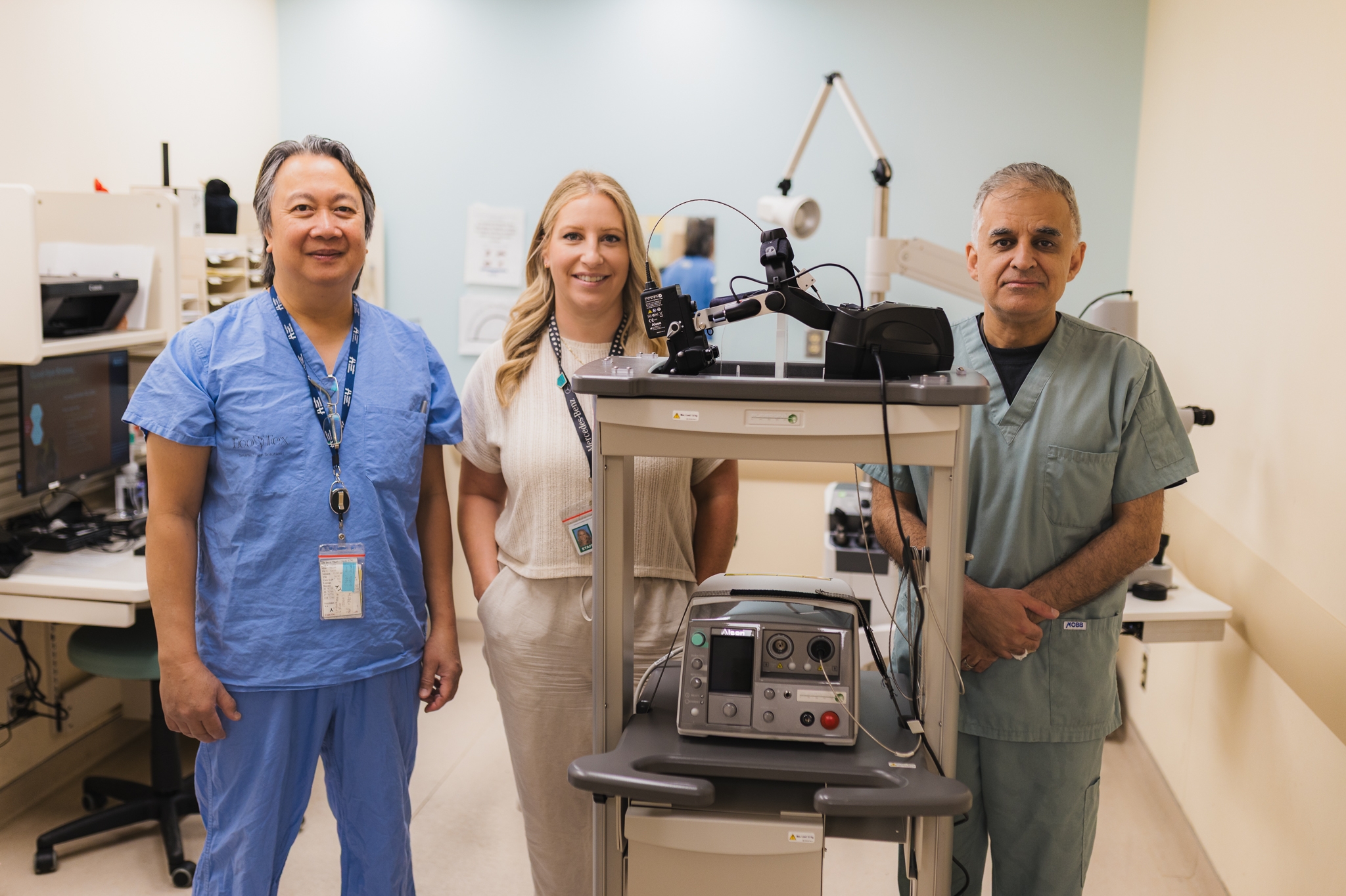 Service resource nurse Willy Ramos, OR manager Emily Peters, and pediatric ophthalmologist Dr. Kourosh Sabri stand left to right with the new sight-saving laser machine at HHS McMaster Children's Hospital.