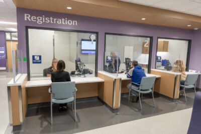 People sitting at registration desks