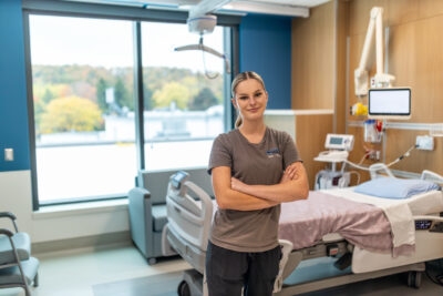A hospital room features a large window