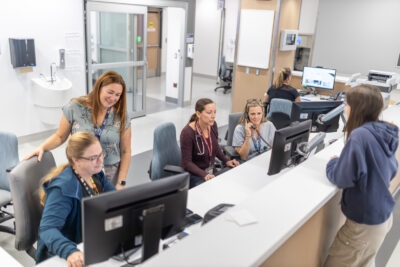 Several staff at a nursing station
